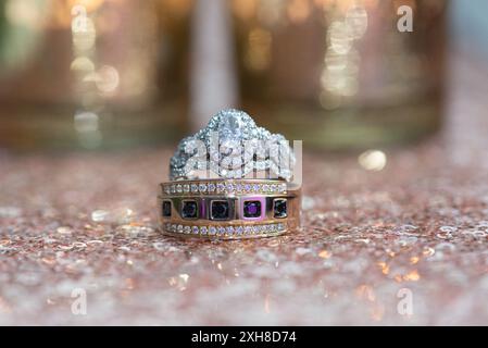 whimsical wedding bands on pink blingy surface with blingy bokeh background Stock Photo