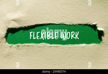 Flexible work message written on ripped torn paper with green background. Conceptual flexible work symbol. Copy space. Stock Photo