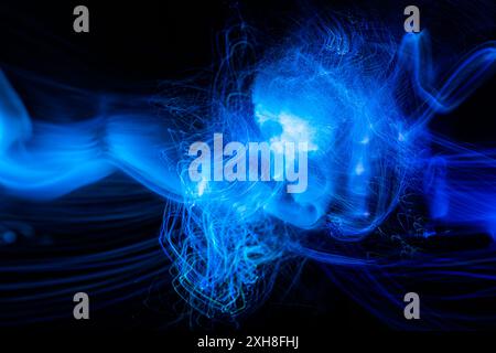 Blue Light wave of energy explosion with elegant glowing lines. Abstract technology background. Stock Photo