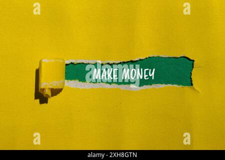 Make money message written on ripped yellow paper with green background. Conceptual make money symbol. Copy space. Stock Photo