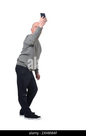 man taking a self-portrait from above on white background Stock Photo