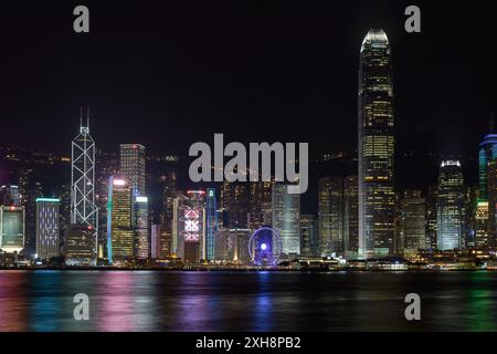 Hong Kong, China - April 28, 2017: City Lights at Skyscrapers and Buildings View Over Victoria Harbour at Night. Stock Photo