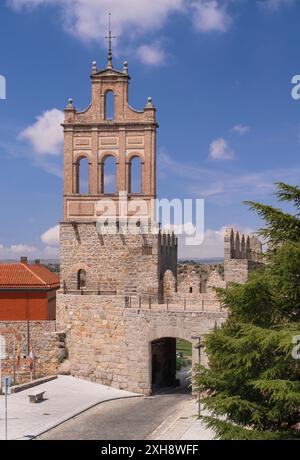 Spain, Castile and Leon, Avila, City walls with the brick steeple of the former Carmelite convent El Carmen above the Puerta del Carmen viewed from the walkway along the top perimeter of the walls. Stock Photo