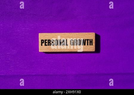 Personal growth message written on wooden blocks with purple background. Conceptual personal growth symbol. Copy space. Stock Photo