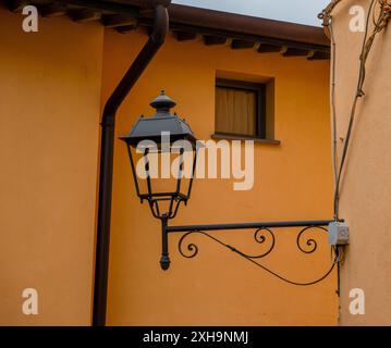 Wrought iron street lamp in the village of Loano Stock Photo