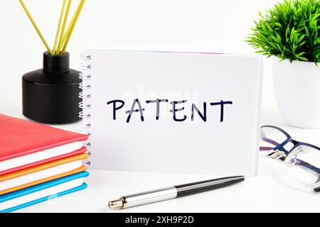 Patents Business concept. PATENT in a notebook on a light background in a composition with business accessories Stock Photo