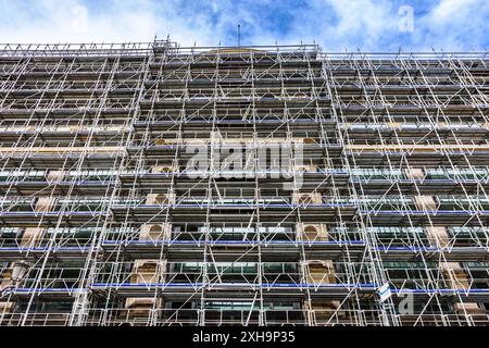 Large renovation project of facade of building covered in Entrepose scaffolding on the rue de Rivoli, Paris 75001, France. Stock Photo