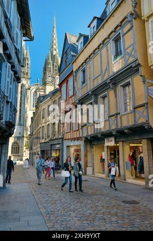 Cathedral of Saint Corentin seen beyond shops on Rue Kereon in the mediaeval city centre of Quimper, Finistere, Brittany, France Stock Photo