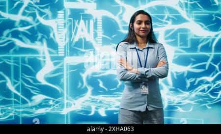 Portrait of smiling technician running artificial intelligence programming scripts. Joyful admin working in IT department tasked with AI applications development, camera A Stock Photo
