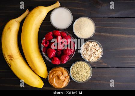 Banana Raspberry Smoothie Ingredients: Fresh fruit with almond milk, protein powder, rolled oats, hemp. hearts, and almond butter Stock Photo