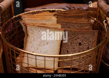 Sliced bread in a basket on a table in a bakery Stock Photo