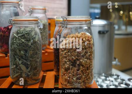 Various kinds of herbal tea in glass jars on wooden pallets Stock Photo