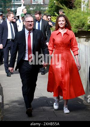 Keir Starmer, leader of the Labour Party and his wife Victoria Starmer arrive to cast their votes in the general election in London, England. Stock Photo