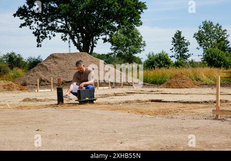 One male construction worker working on a construction site. Building own family house concept  Stock Photo