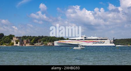 HSC Condor Ferry Liberation departing Poole Harbour, with Brownsea Island in the distance, Dorset, UK Stock Photo