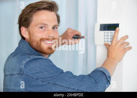 man installing ip wireless cctv camera Stock Photo