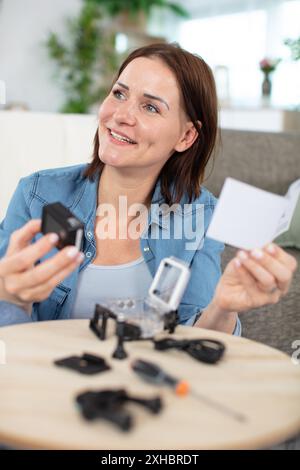 woman installing surveillance cctv cameras at home Stock Photo