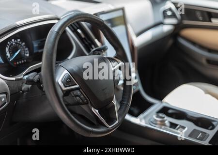 Car interior with steering wheel and control panel Stock Photo