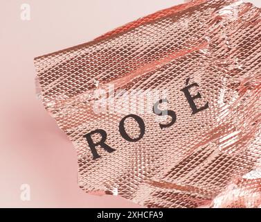 Aluminum foil with the words rose on a pink background with space for text Stock Photo