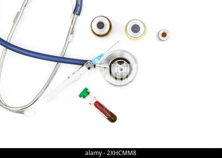 Medical equipment on doctor's desk, stethoscope ampules and syringe on white background with copy space, close-up. Health care concept Stock Photo