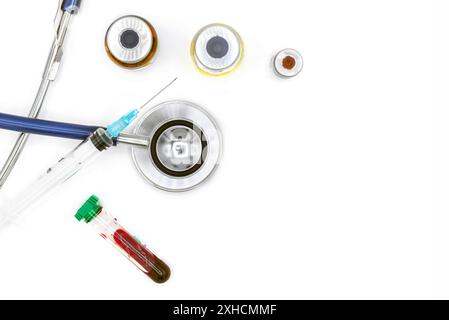 Medical equipment on doctor's desk, stethoscope ampules and syringe on white background with copy space, close-up. Health care concept Stock Photo