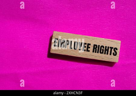 Employee rights words written on wooden block with pink background. Conceptual employee rights symbol. Copy space. Stock Photo