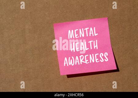 Mental health awareness message written on ripped paper with cardboard ...