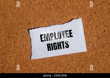 Employee rights words written on ripped white paper with brown background. Conceptual employee rights symbol. Copy space. Stock Photo