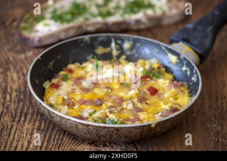 Scrambled eggs in a pan on wood Stock Photo