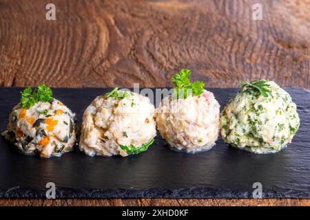 Four different dumplings on slate Stock Photo