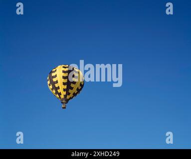 Black and yellow hot air ballon in flight, Gatineau, Outaouais, Quebec, Canada Stock Photo