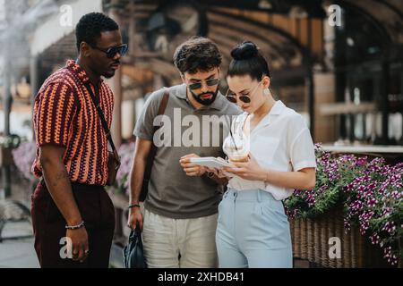 Business people discussing work in an outdoor meeting, collaborating over documents and ideas Stock Photo
