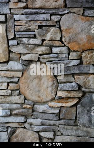 Closeup of a stone wall with round decorative stones inserted. Stock Photo