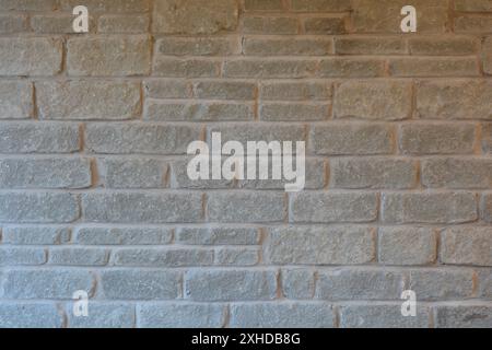 Close up of a rectangular gray stone wall fireplace. Stock Photo