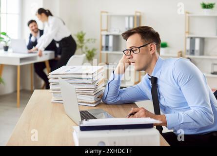 Tired Businessman Sleeping At Desk While Working In Office Stock Photo