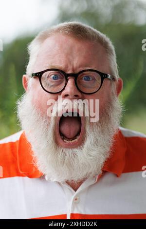 Portrait from emotional screaming senior man with beard Stock Photo