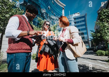 Confident entrepreneurs discussing start-up strategies outdoors Stock Photo