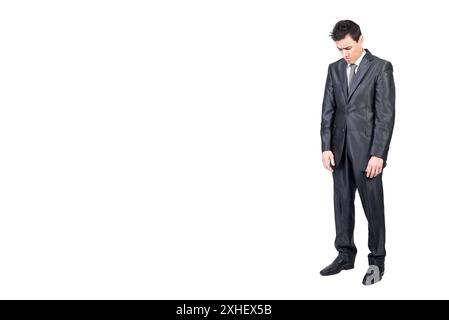 Sad young male manager looking down in white studio Stock Photo