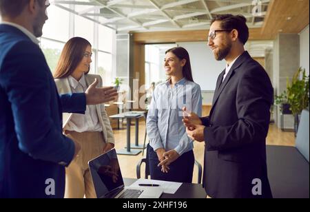 Business people chatting on meeting. Company employees talking in office. Team work concept. Stock Photo