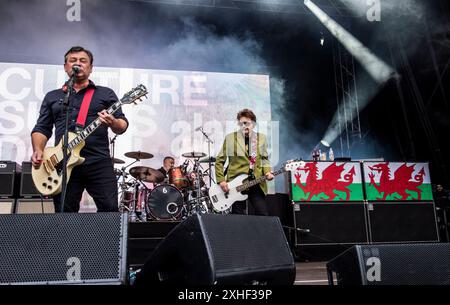 Leeds, UK. 13th July, 2024. Welsh rock band The Manic Street Preachers playing live in Millennium Square in the centre of the city. From left to right, lead vocalist James Dean Bradfield, drummer Sean Moore and bassist Nicky Wire. Credit: ernesto rogata/Alamy Live News Stock Photo