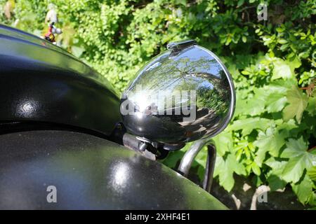 Lingen, Germany - May 13 2024 A chrome headlight of a parked black citroën deux cheveaux. Stock Photo