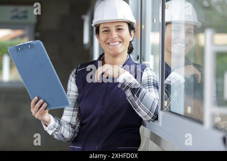 happy builder woman holding a clipboard Stock Photo