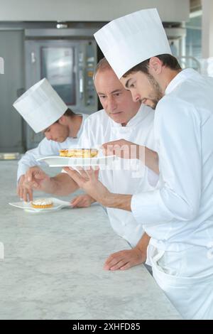 chef putting finishing touch on dessert Stock Photo