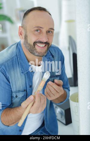 man holding a paint brush Stock Photo