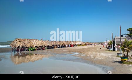 Cartagena, Colombia - 24 January 2024: Row of straw beach huts on Playas de La Boquilla, which is a fishing village on the outskirts of Cartagena Stock Photo