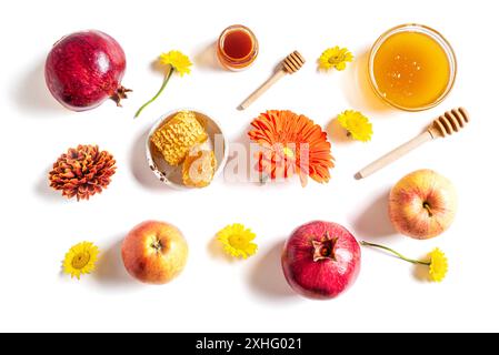 Rosh Hashanah jewish New Year holiday creative pattern. Layout of traditional symbols - apples, honey, pomegranate and flowers isolated on white backg Stock Photo
