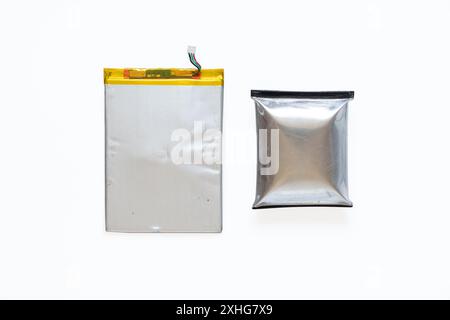 A telephone battery that is swollen from overheating lies on a white background, the phone battery is inflated Stock Photo