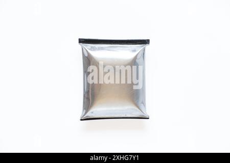 A telephone battery that is swollen from overheating lies on a white background, the phone battery is inflated Stock Photo