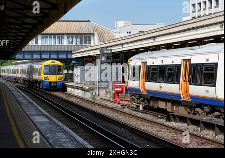 London Overground services at Clapham Junction: Left, the 10:30 service to Dalston Junction; right, the 10:35 service for Stratford Stock Photo