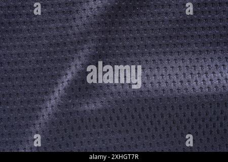 Black fabric sport clothing football jersey with air mesh texture background Stock Photo